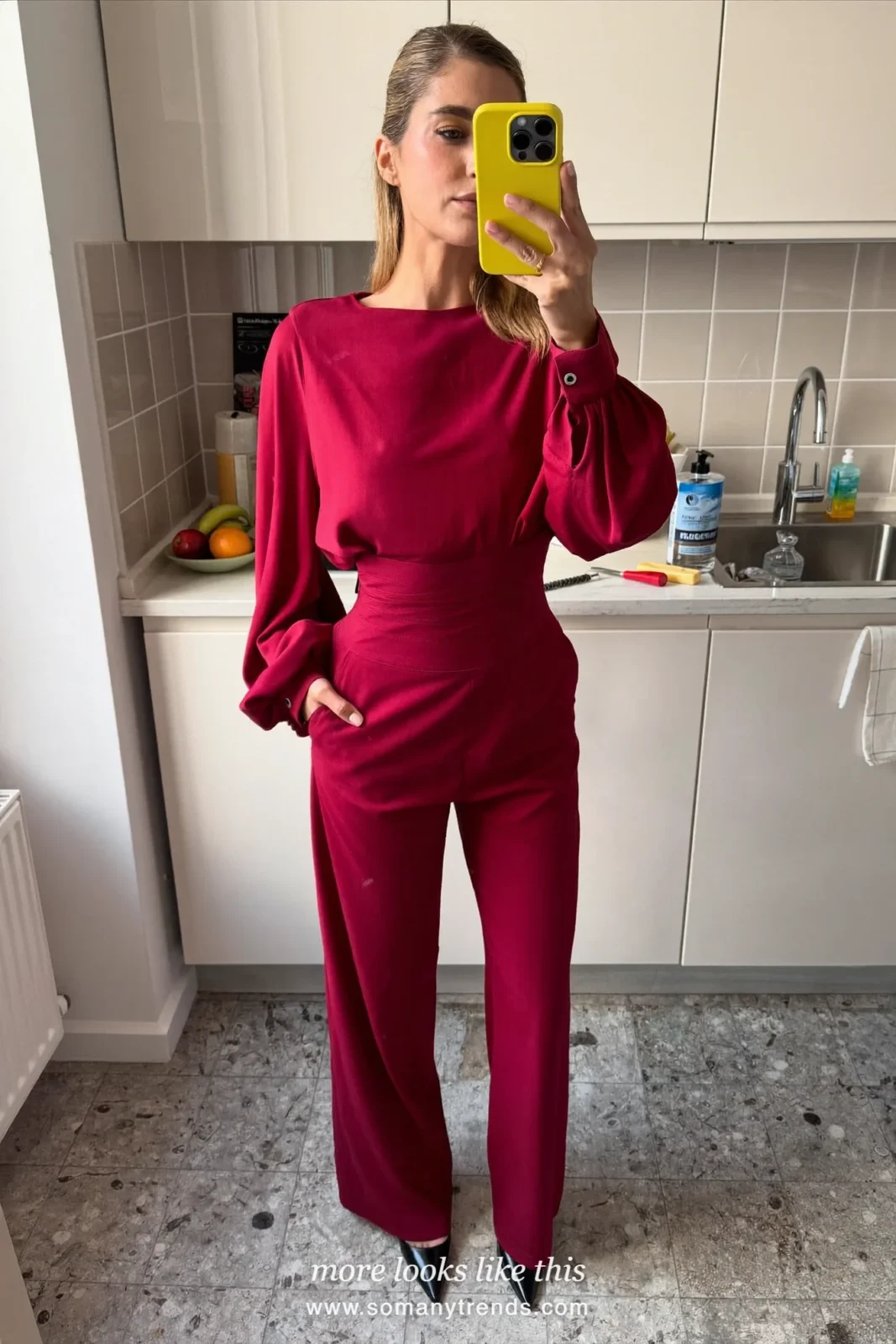 Woman in a wine wide-leg jumpsuit with a blush wrap and pointed pumps at an evening wedding, wedding guest outfit 28
