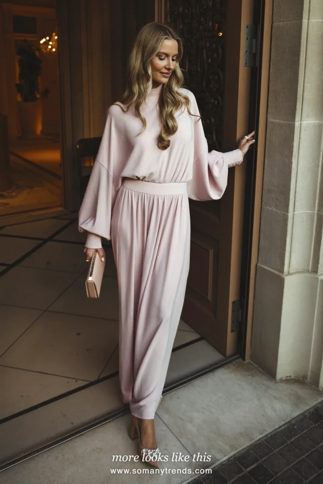 Woman in a blush maxi dress with long sleeves and jeweled heels at an evening wedding, wedding guest outfit 30