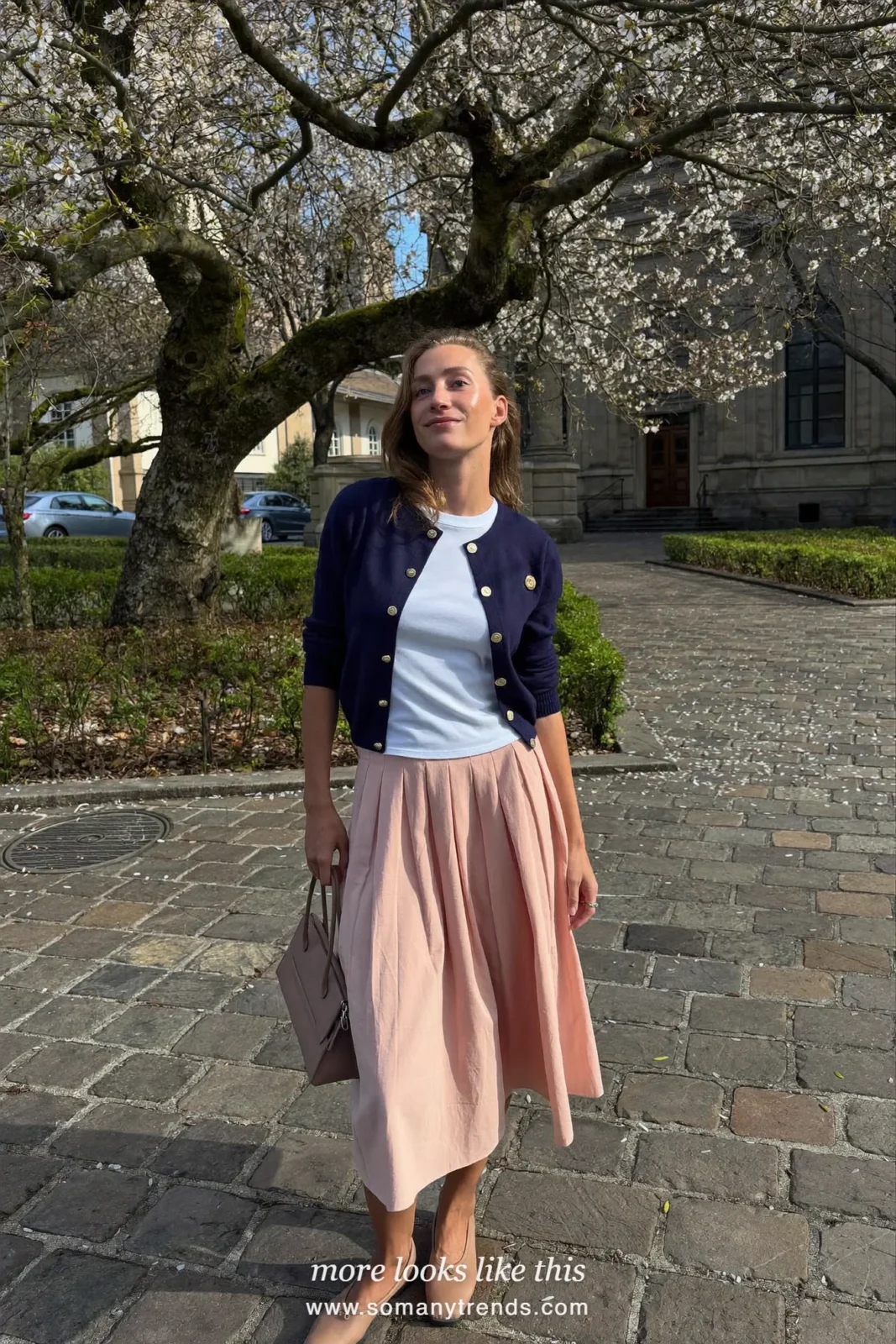 Woman in a navy cardigan, white tee, peach midi skirt and tan flats, Easter outfit 22