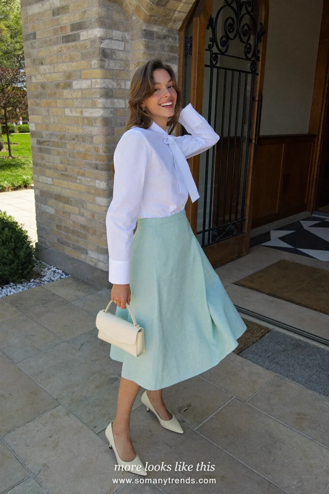 Woman in a white poplin shirt with a bow at the collar, a mint drop-waist midi skirt and cream kitten heels, Easter church outfit 1