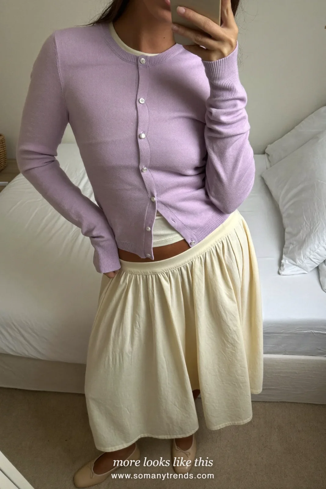Mirror selfie of a woman in a lilac cardigan over a cream tee, a cream midi skirt and nude flats, Easter church outfit 4