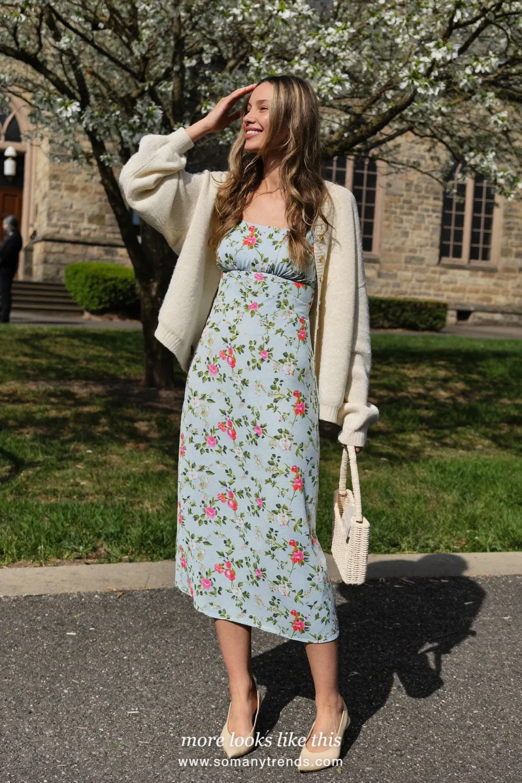 Woman in a pale blue floral midi dress, a cream cardigan over her shoulders area covered, and kitten heels, Easter church outfit 10