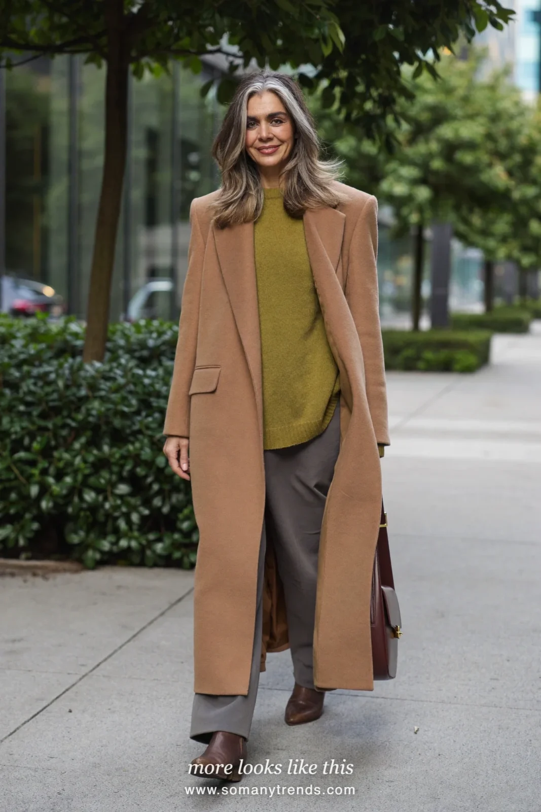 Look 26: long camel coat, pine green fine knit sweater, gray straight pants and brown ankle boots