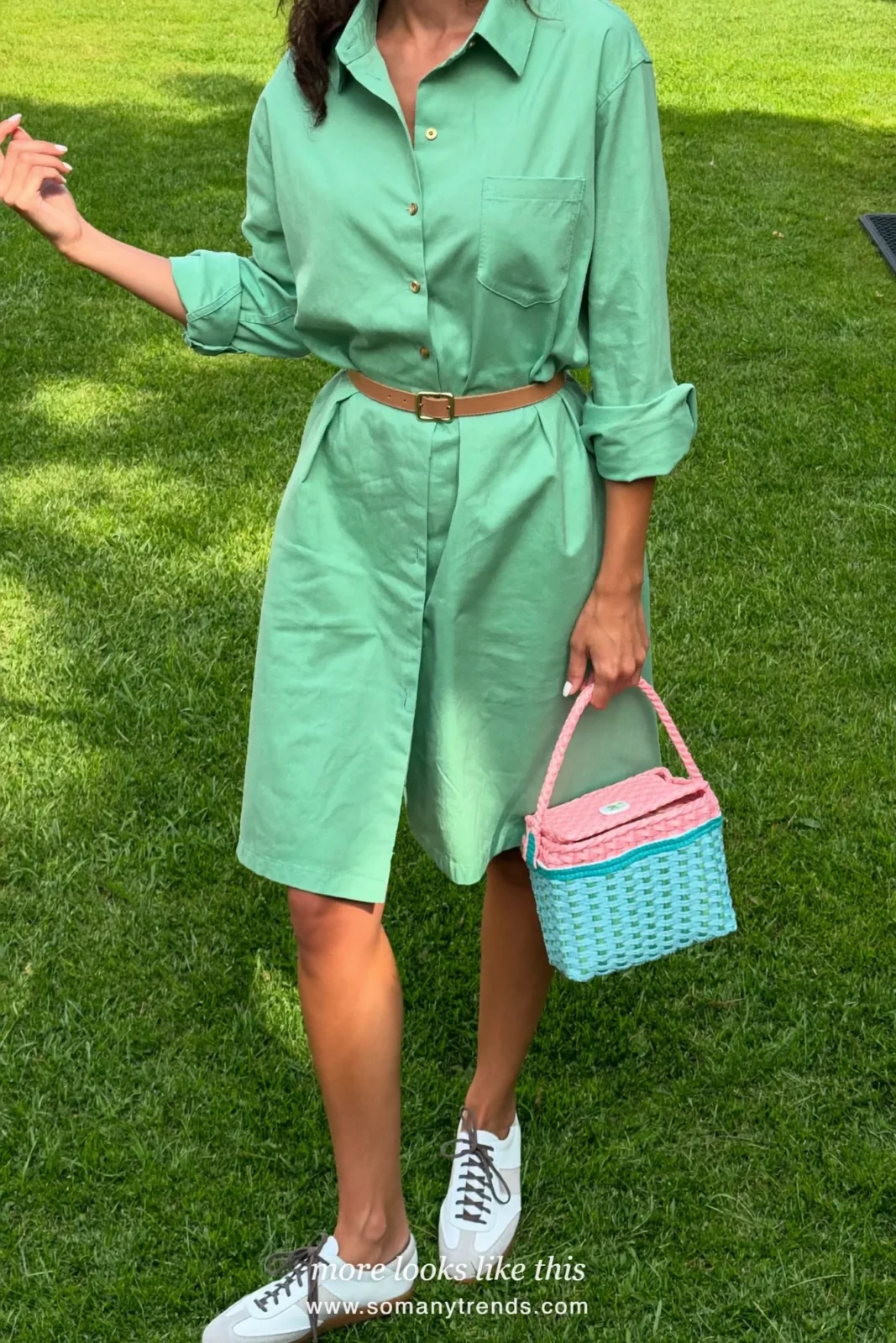 Woman in a mint cotton shirt dress with tan belt and white sneakers on a lawn, Easter outfit 9
