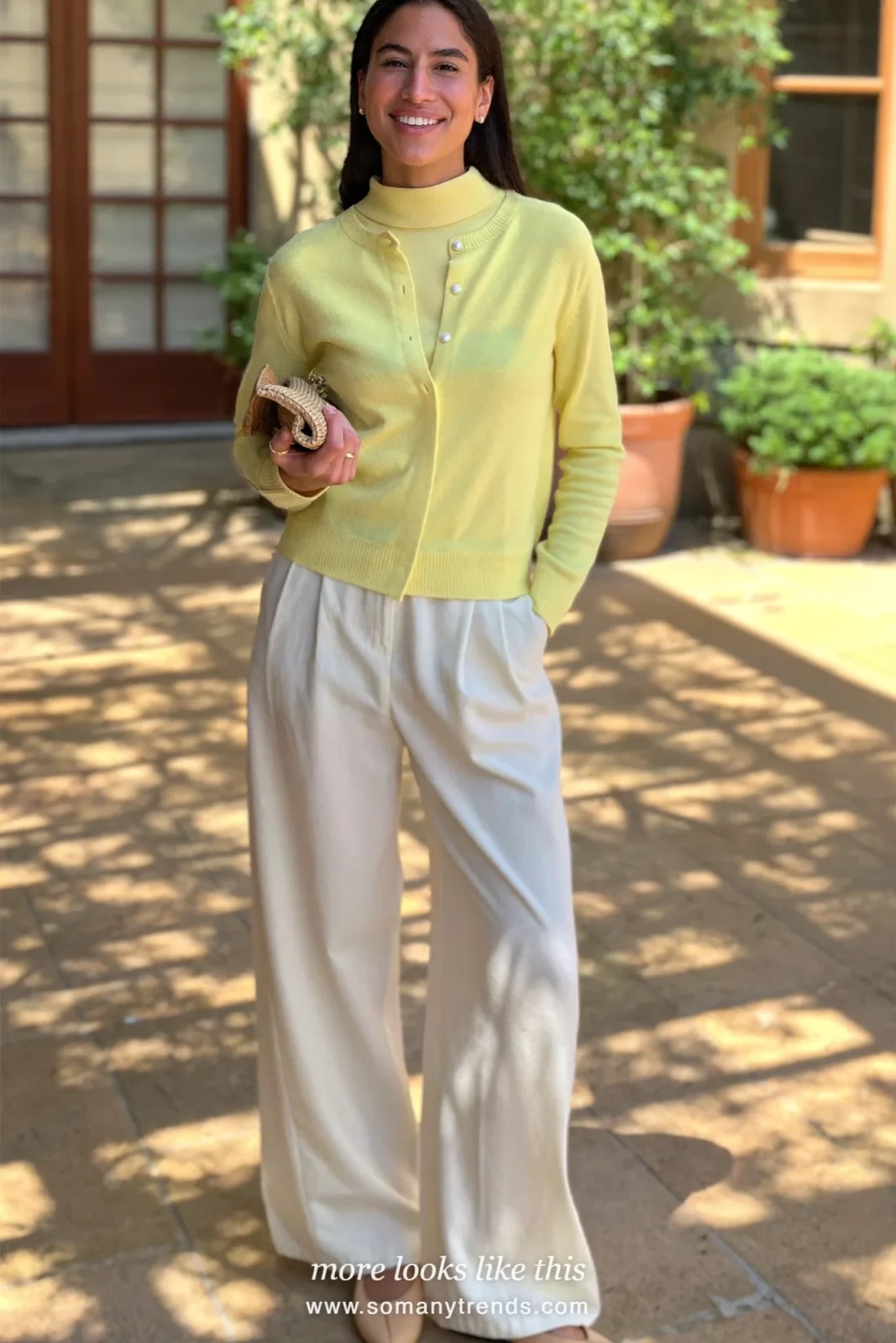Woman in a pale yellow knit cardigan and shell set with ivory wide pants and flats, Easter outfit 13
