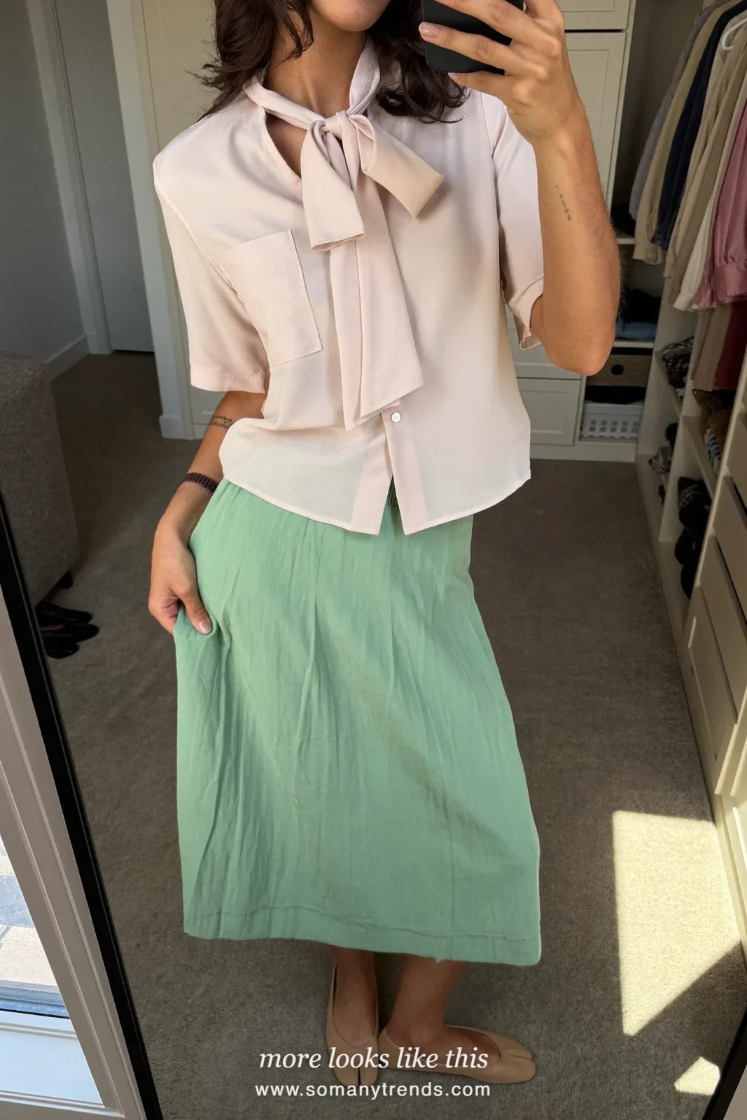 Woman at home in an ivory shirt with bow, mint pleated midi skirt and nude flats, mirror selfie, Easter outfit 32