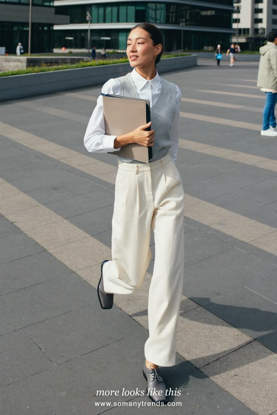 Woman in a gray sleeveless knit vest over a white shirt, ivory wide-leg pants and gray square-toe derbies, outfit 3