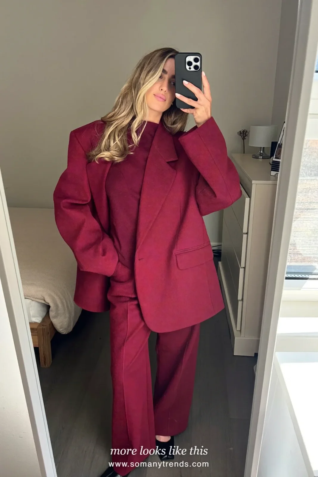 Woman in burgundy wide-leg pants, burgundy fine knit top, lighter burgundy blazer and black square-toe pumps, outfit 8 mirror selfie