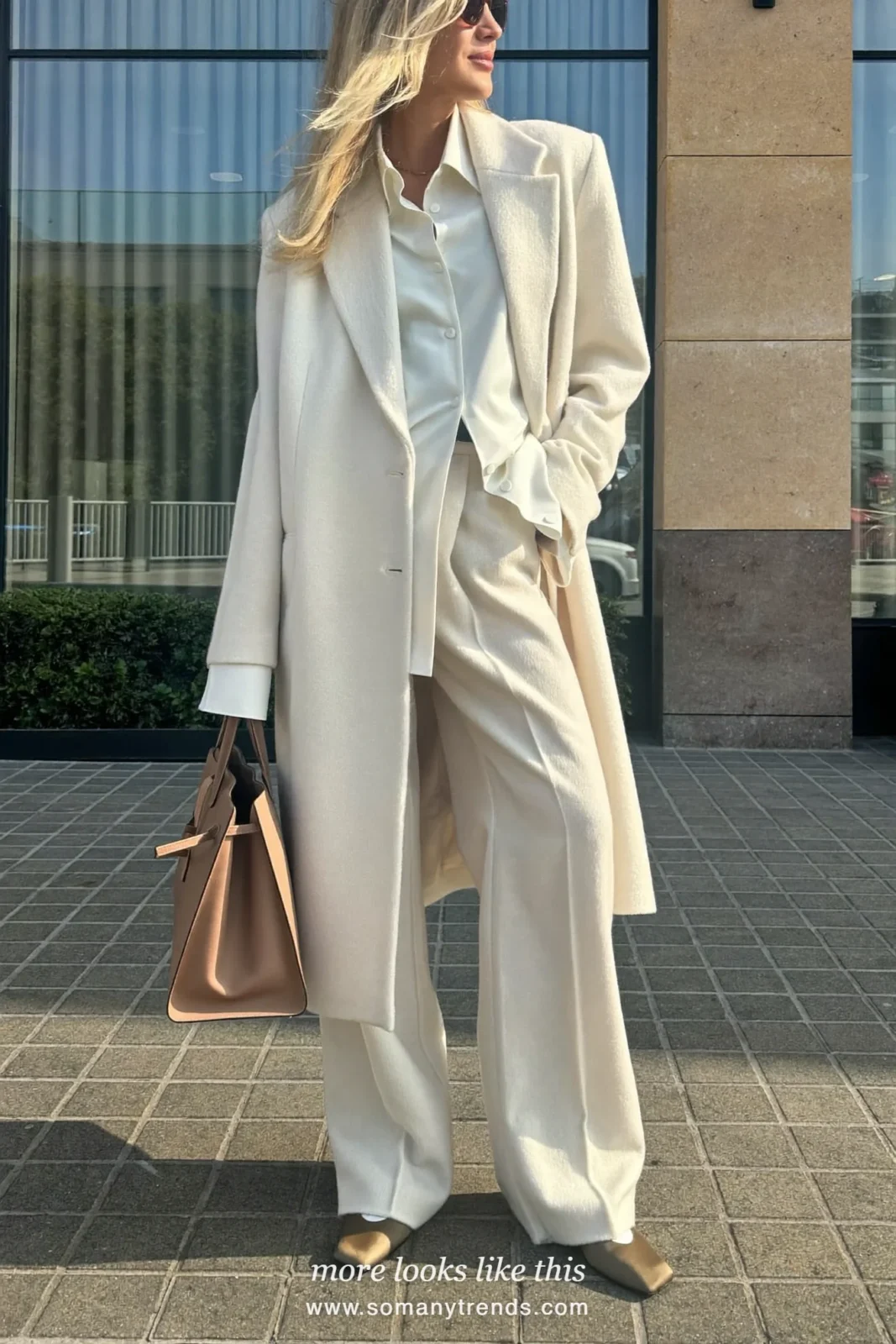 Woman in an ivory shirt, cream long blazer, ivory wide-leg pants and taupe square-toe pumps, outfit 23