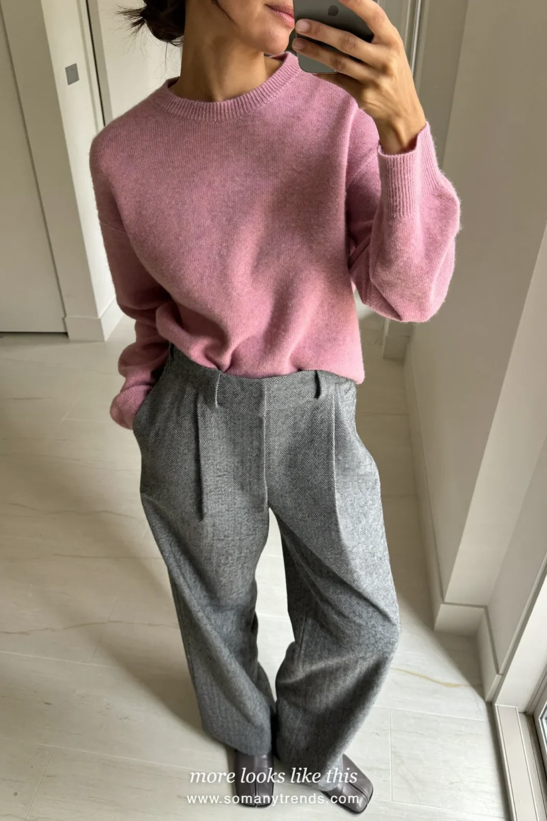 Woman in a long camel coat, dusty pink knit, gray wide-leg pants and gray square-toe ankle boots, outfit 32 mirror selfie