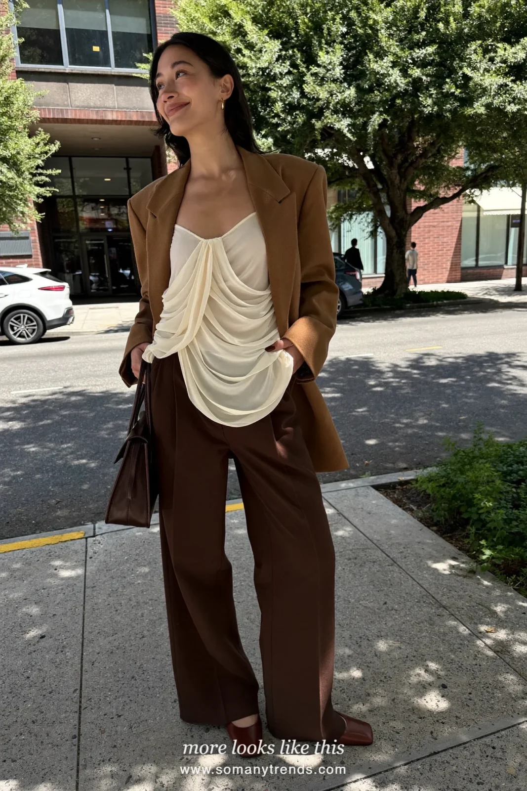 Woman in a camel long blazer, ivory shell top, chocolate wide-leg pants and brown square-toe pumps, outfit 15