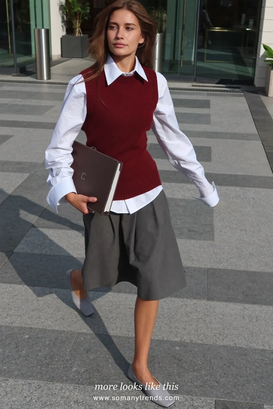 Woman in a burgundy knit vest, white shirt, gray poplin midi skirt and gray square-toe flats, outfit 22