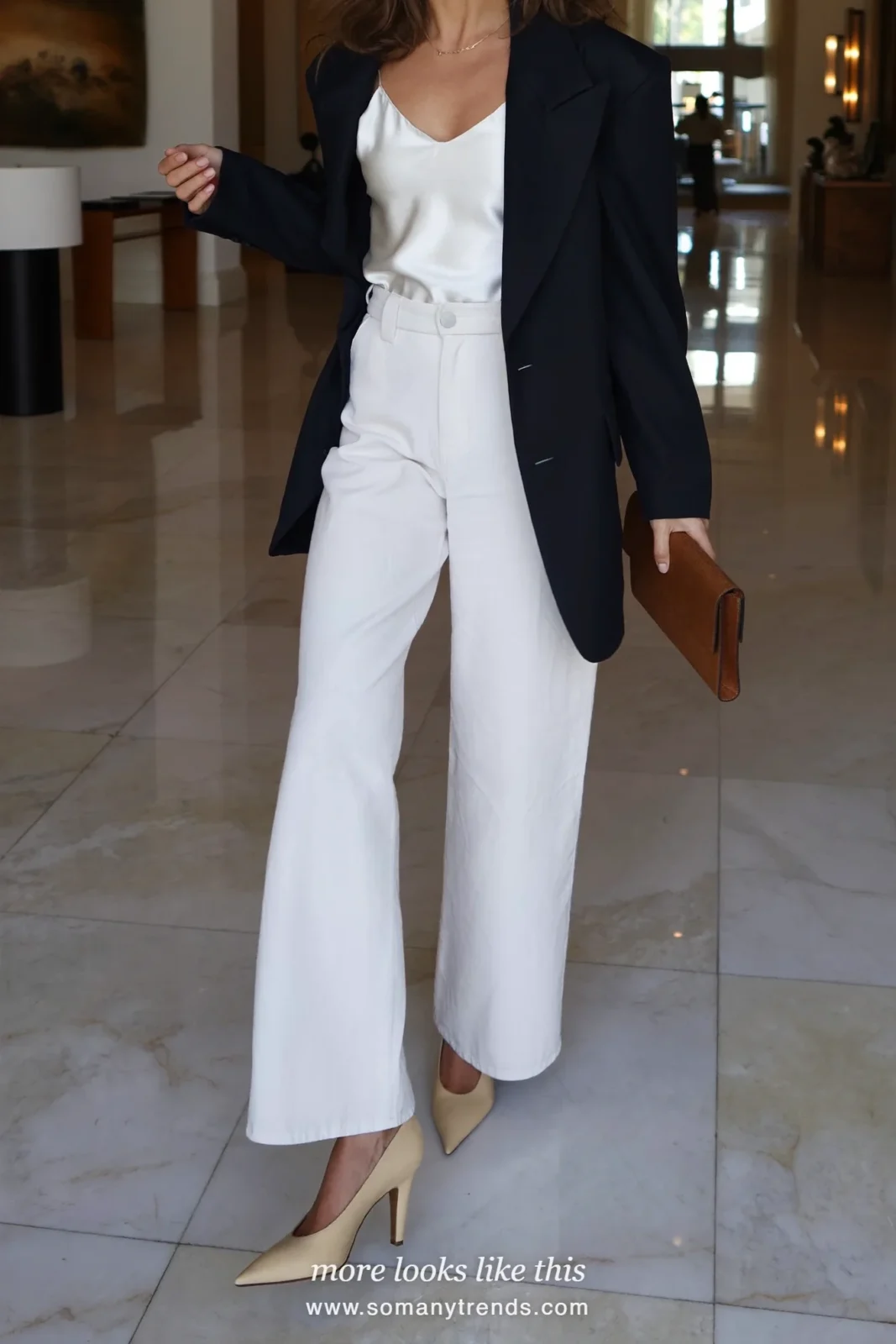 Woman in a navy blazer, ivory silk camisole, cream wide-leg pants and pumps at a networking event, work conference outfit 19