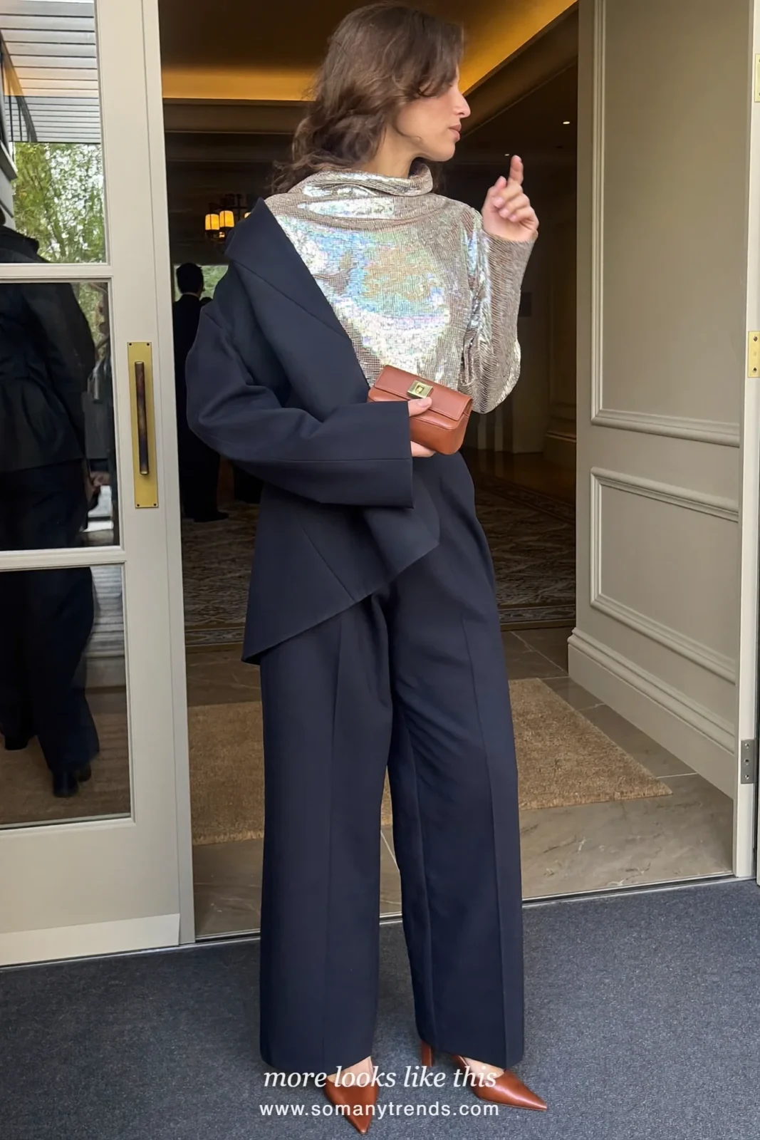 Woman in a champagne sequin top, navy blazer, navy wide-leg pants and pointed pumps at a reception, work conference outfit 25