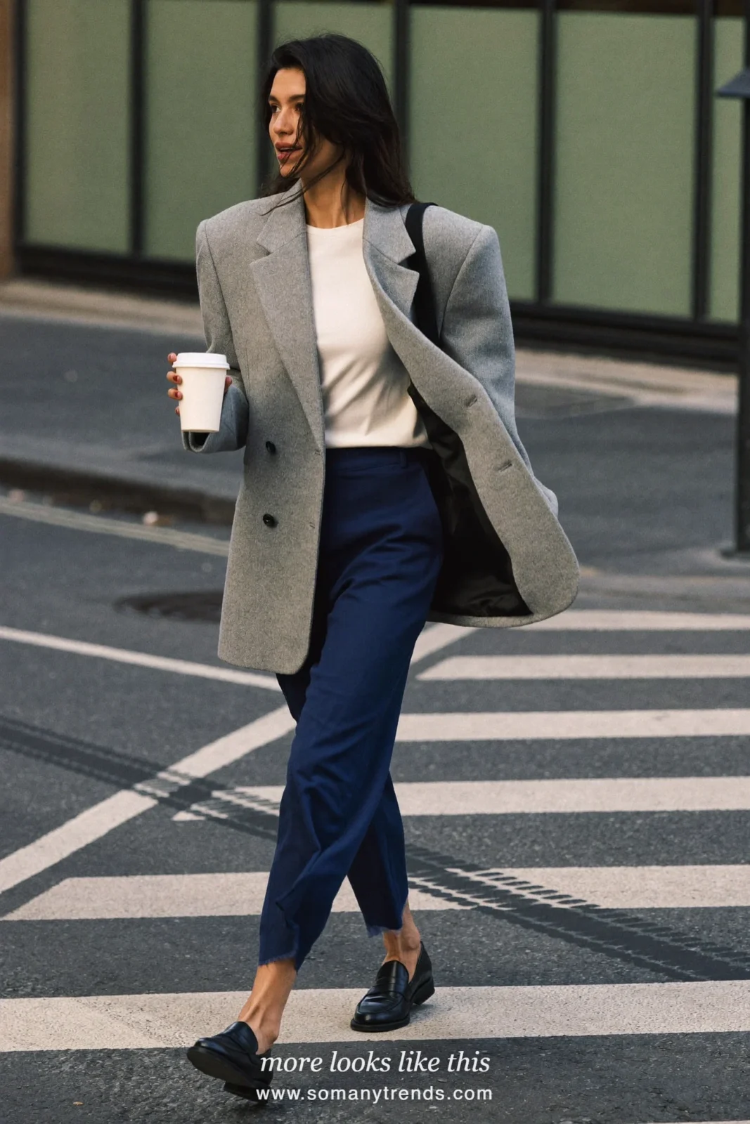 Woman in a soft gray oversized blazer, ivory tee, ink blue wide-leg pants and black leather loafers, first day at work outfit 6