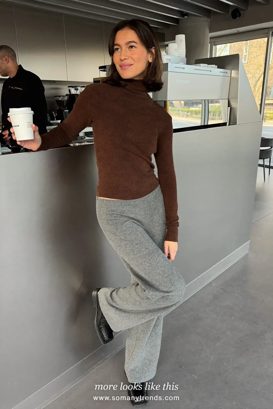 Woman in a chocolate brown fine knit turtleneck, soft gray straight wool pants and black leather loafers, first day at work outfit 15