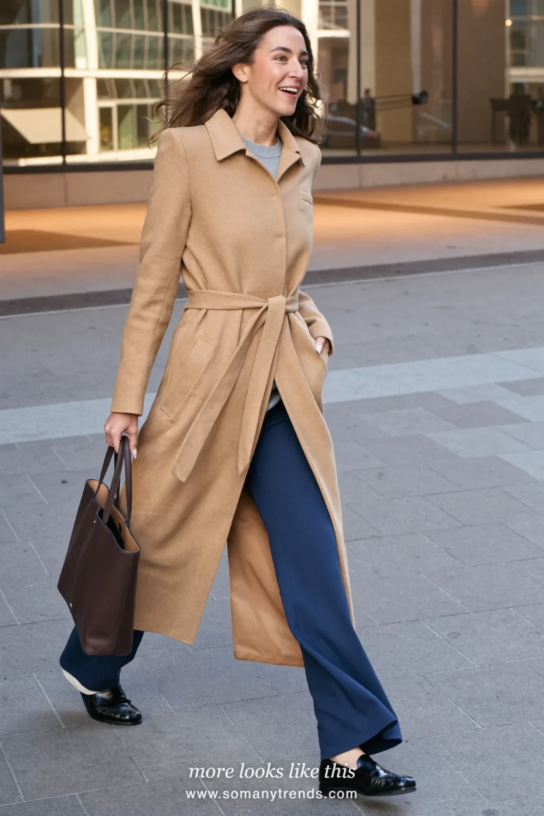 Woman in a camel belted long wool cardigan coat, gray fine knit top, ink blue wide-leg pants and black loafers, first day at work outfit 18
