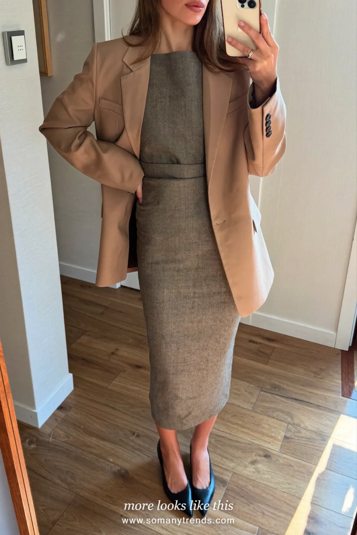 Woman in a gray crepe column dress, camel boxy blazer and black pointed flats, first day at work outfit 20