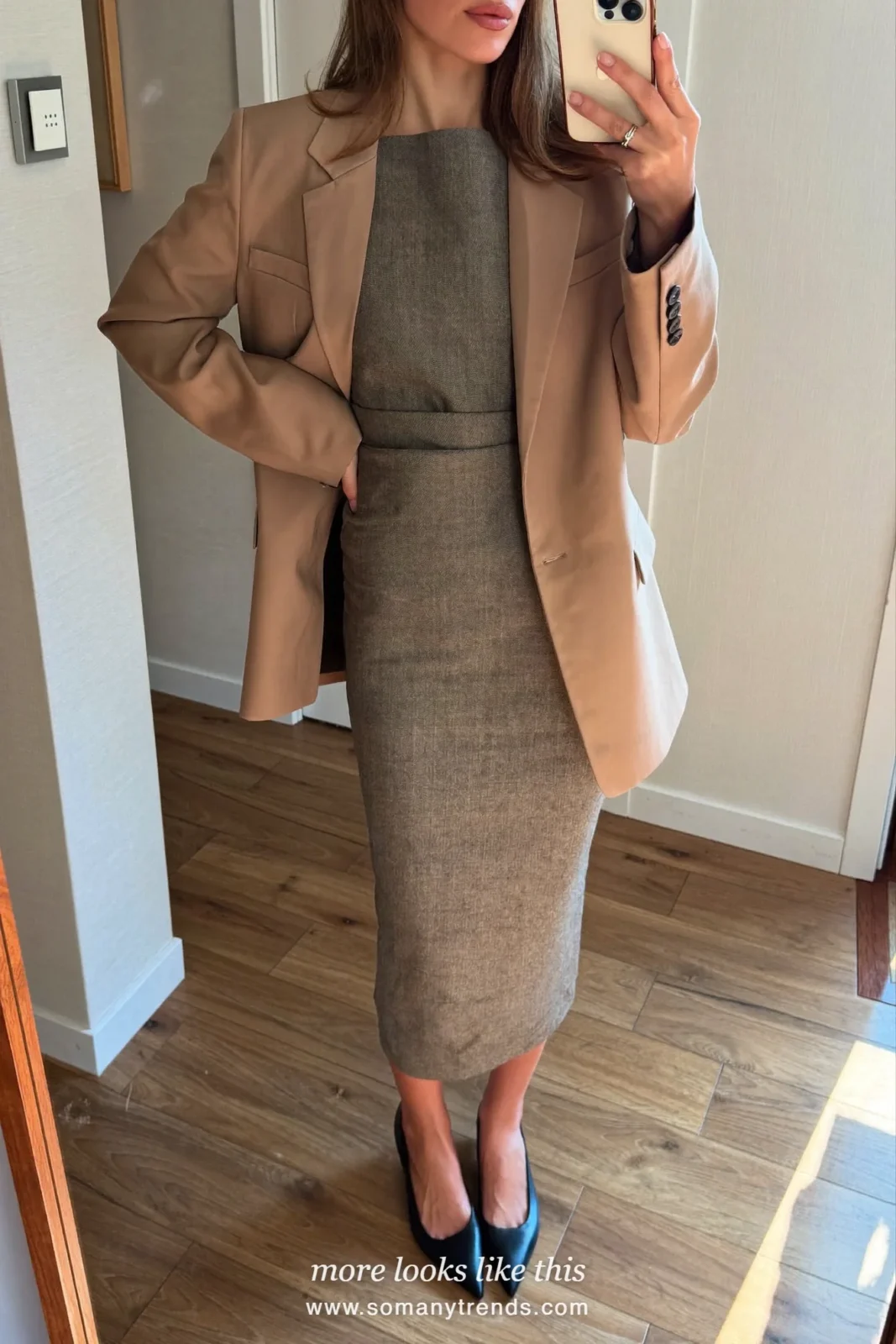 Woman in a gray crepe column dress, camel boxy blazer and black pointed flats, first day at work outfit 20