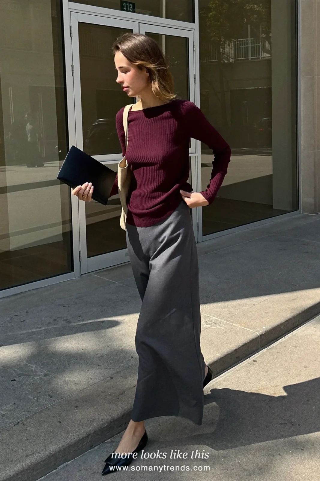 Woman in a charcoal column maxi skirt, burgundy knit top and pointed flats at a conference, work conference outfit 22
