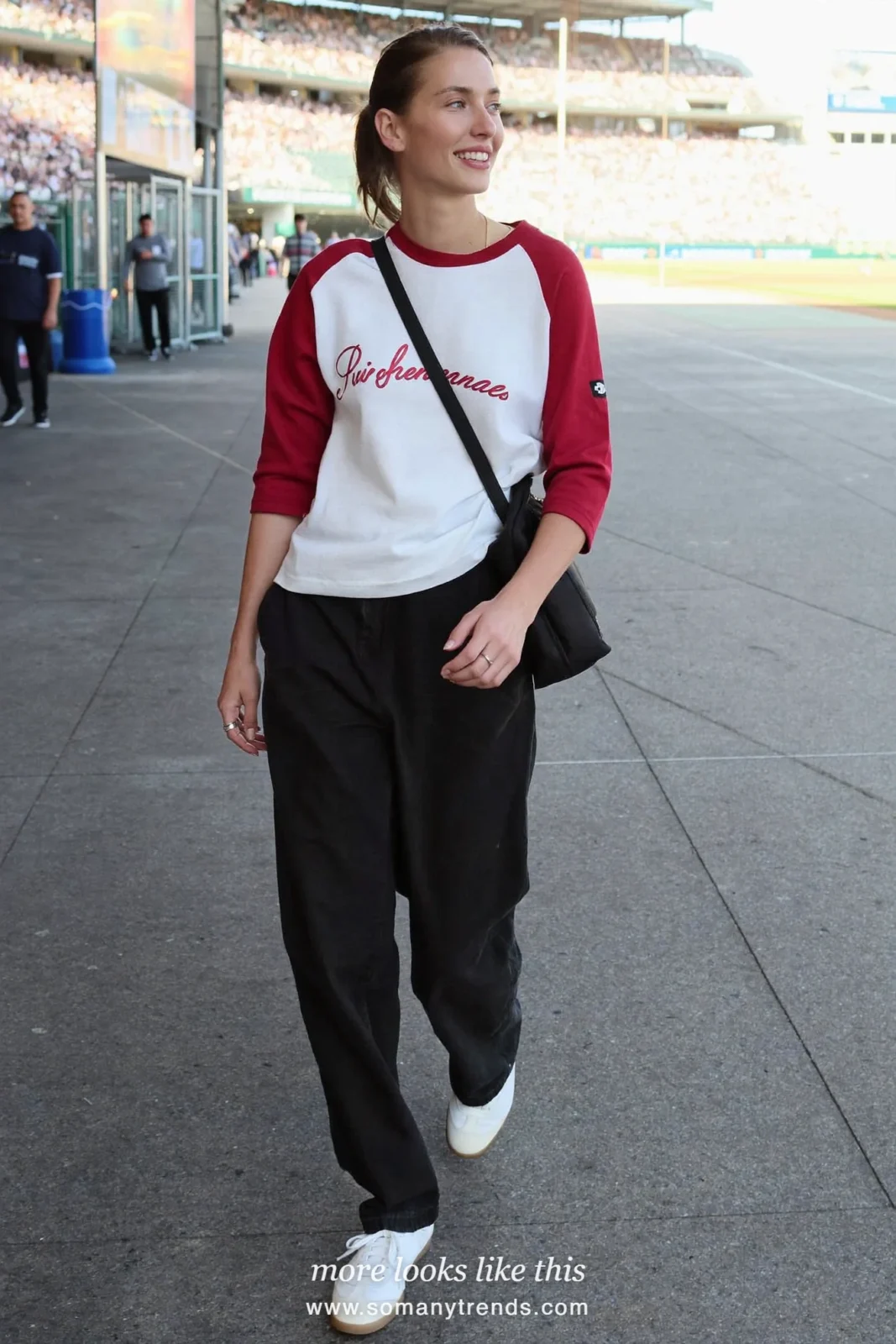 Wine and white raglan baseball tee with black wide-leg pants, white leather sneakers and small black crossbody bag, outfit 1