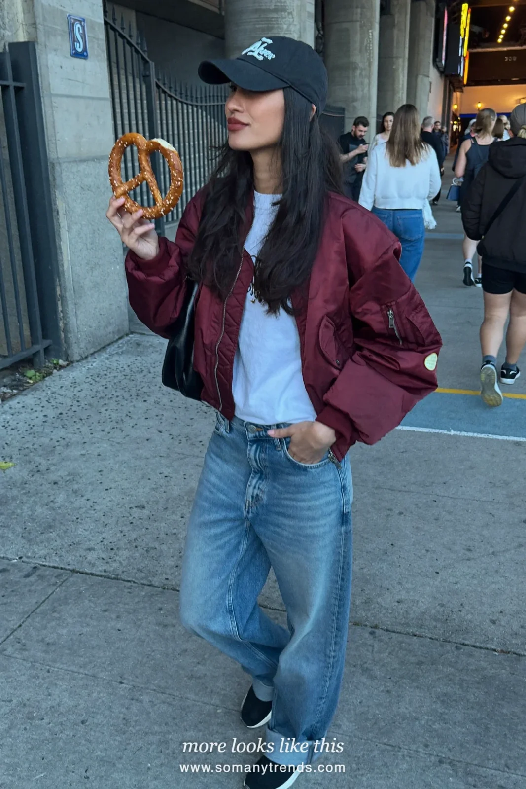 Wine bomber jacket over white tee with relaxed blue jeans, black sneakers and black cap, outfit 13