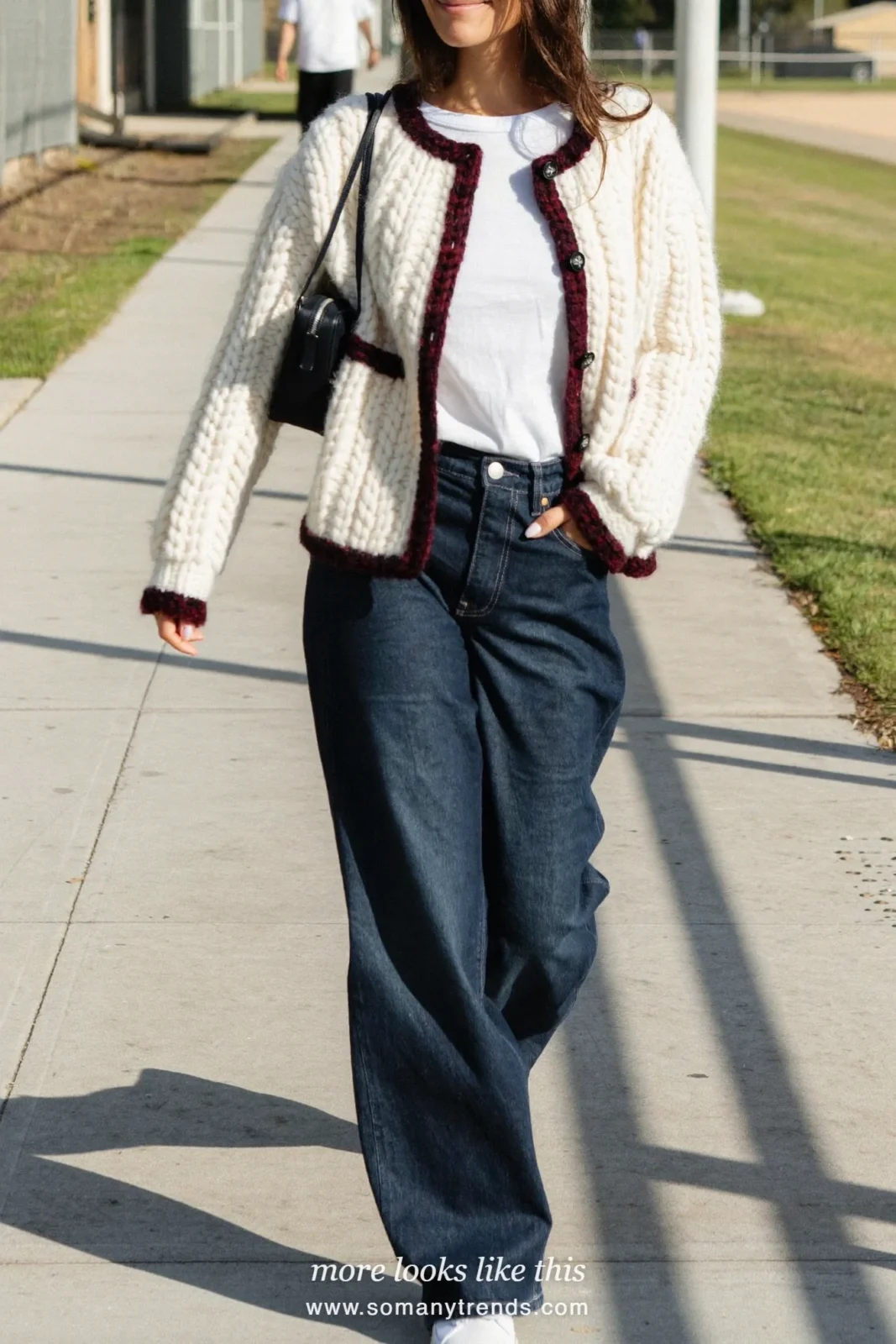 Cream cardigan with wine trim over white tee with dark wide-leg jeans and white sneakers, outfit 14