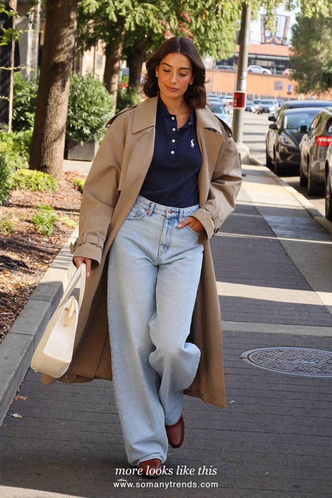 Stone trench coat over navy polo with light jeans, brown loafers and small tote, outfit 19
