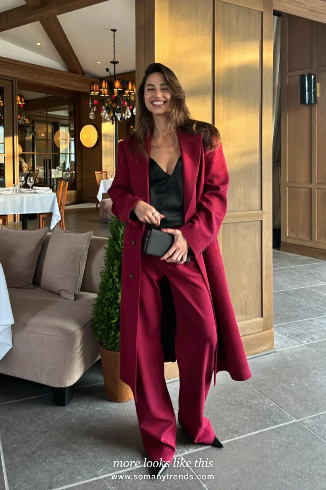 Woman in a burgundy relaxed blazer and wide-leg pants with a black camisole and pointed pumps at a dinner, outfit 23