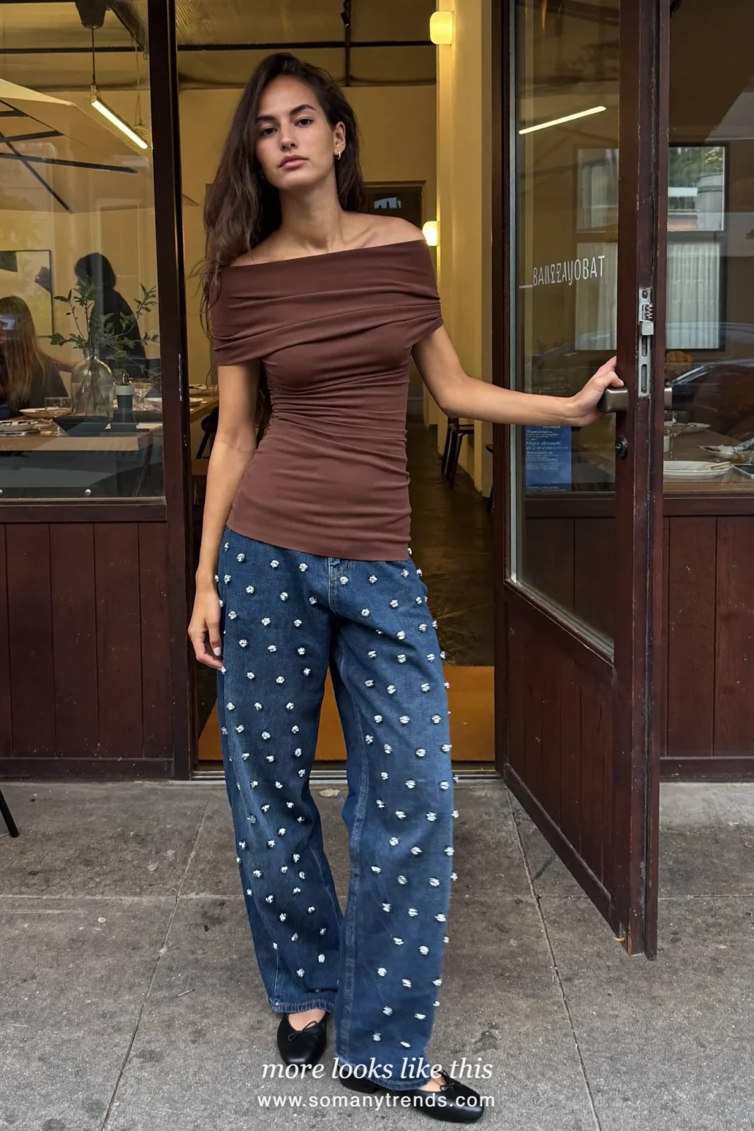 Woman in a brown off-the-shoulder top, crystal-embellished jeans and black ballet flats, outfit 2