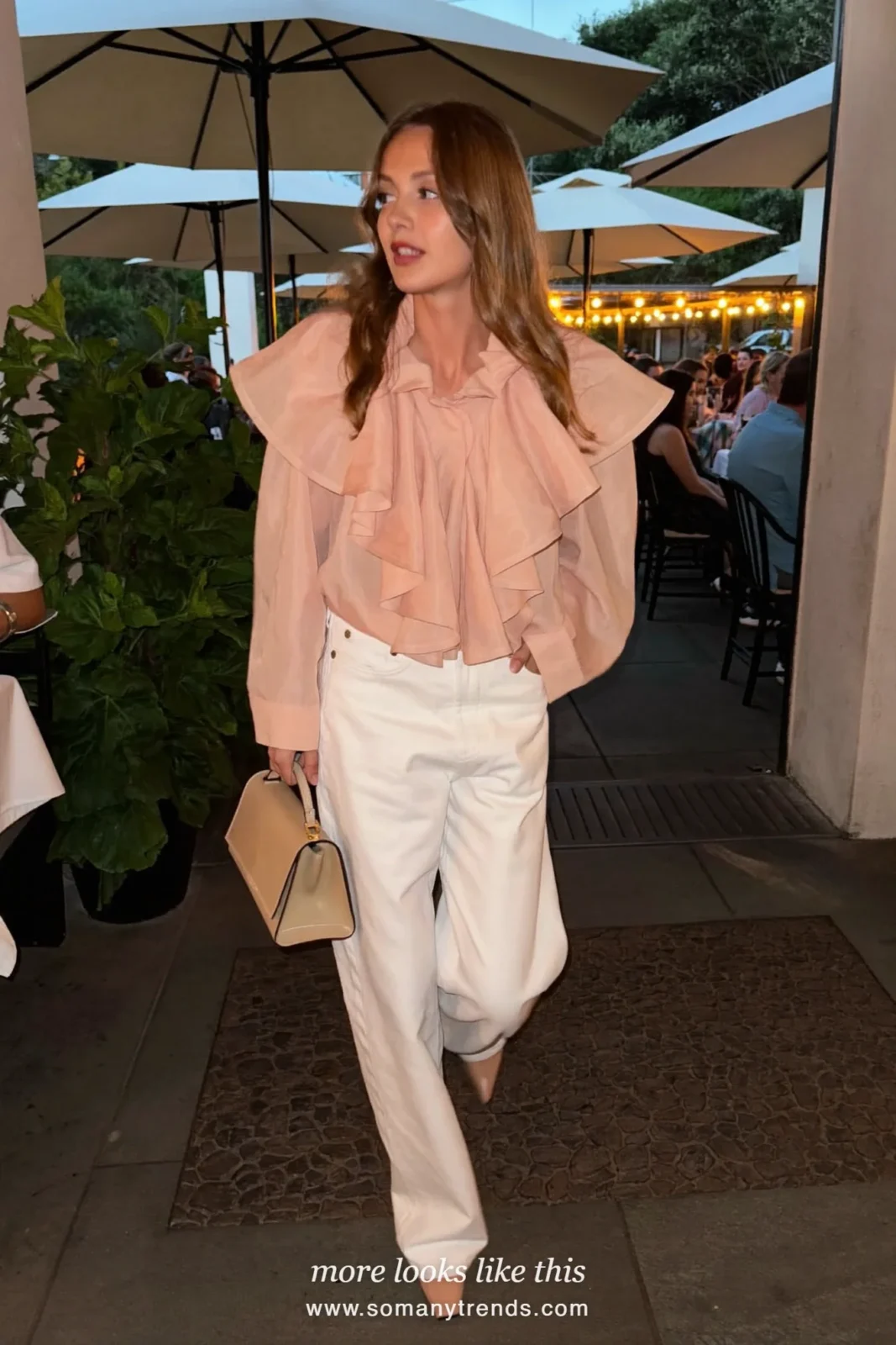Woman in a blush pink ruffle blouse, white straight jeans and sand pointed heels, outfit 7