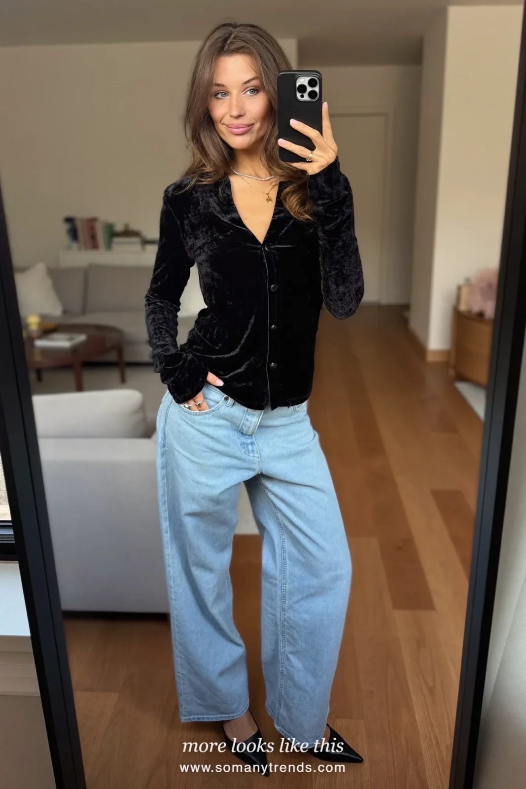 Woman in a black velvet top, light baby blue jeans and black pointed pumps, mirror selfie, outfit 12
