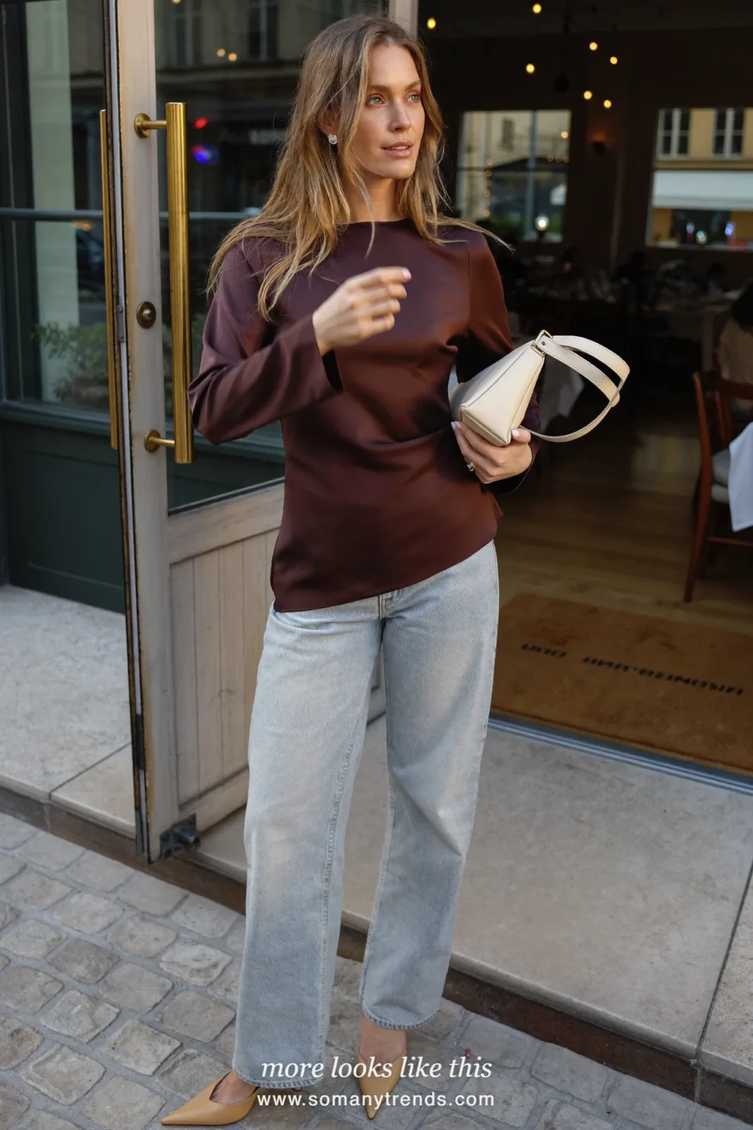 Woman in a chocolate brown satin top, light wash straight jeans and sand pointed heels, outfit 17