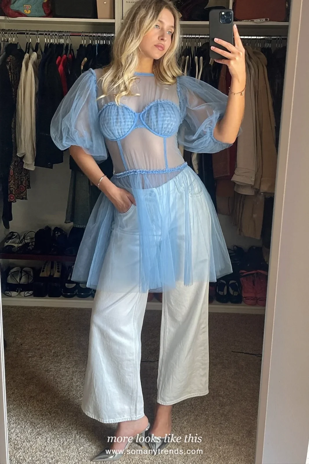 Woman in a baby blue tulle top, white straight jeans and silver kitten heels, outfit 20