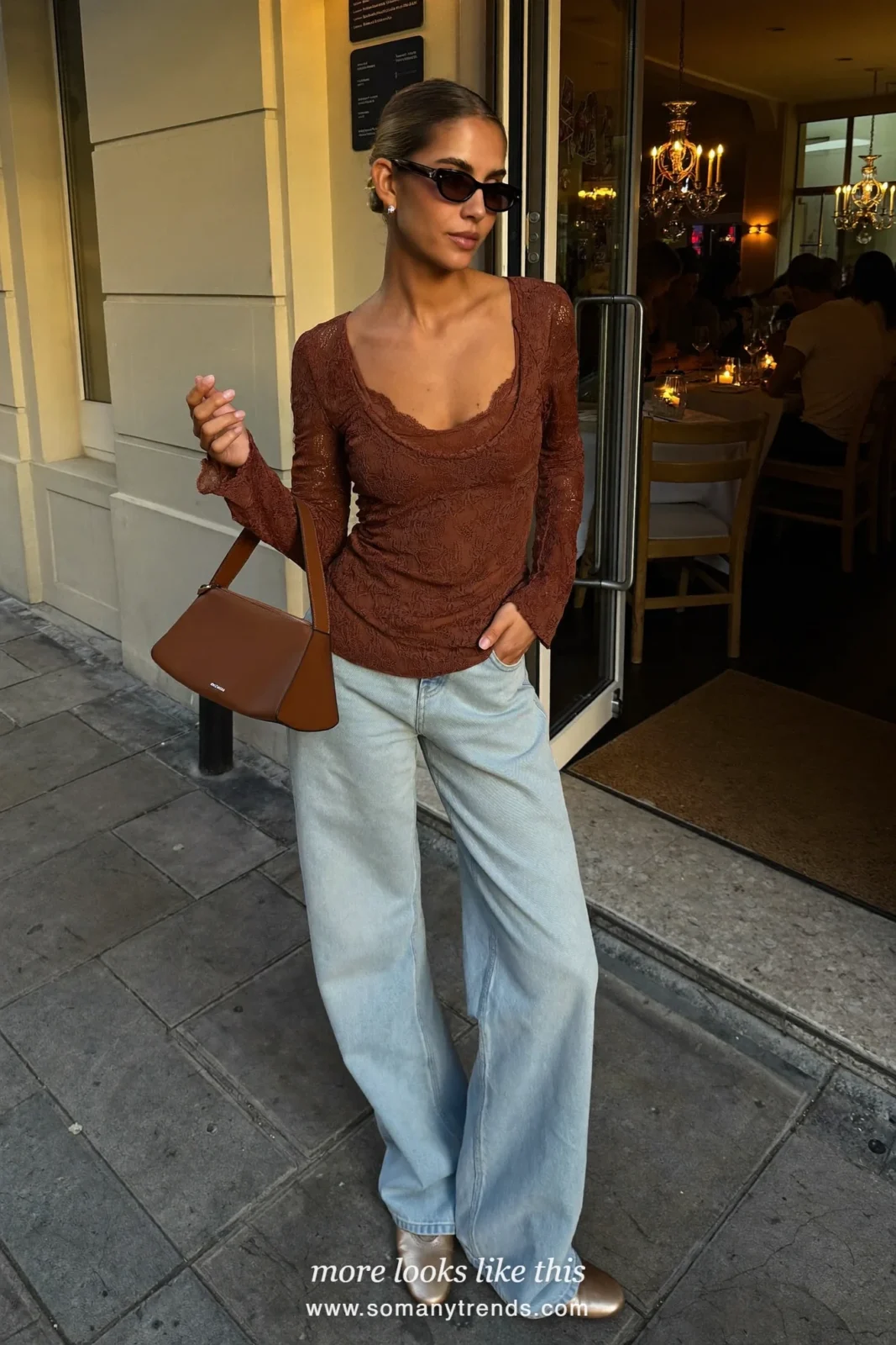 Woman in a chocolate brown lace top, light wide-leg jeans and sand pointed flats, outfit 26