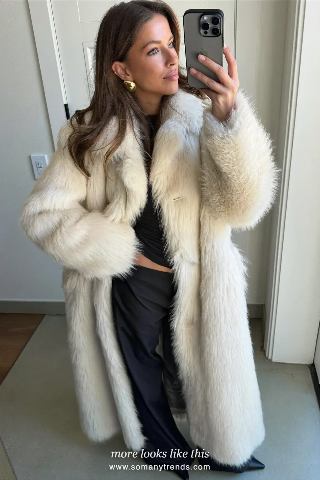 Woman in an ivory faux fur coat, black fitted top, wide-leg black pants and black boots, party outfit 8