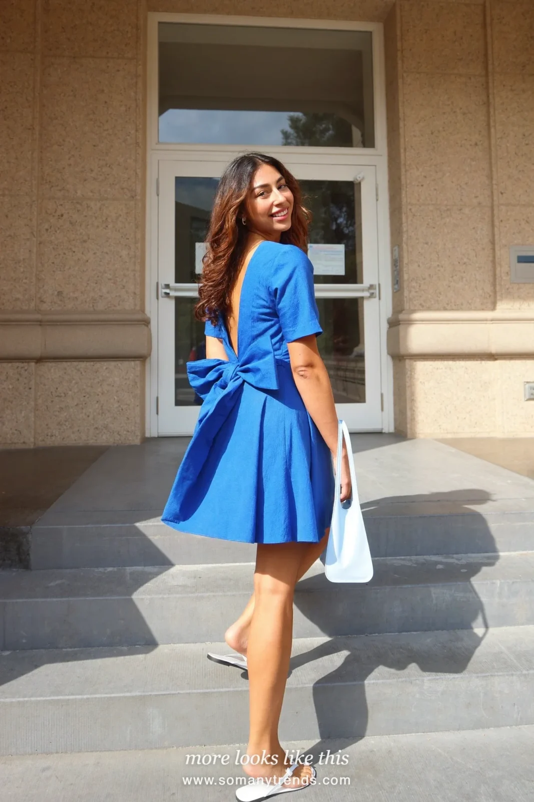 Cobalt blue knee-length dress with a bow at the back and white sandals, graduation outfit 25