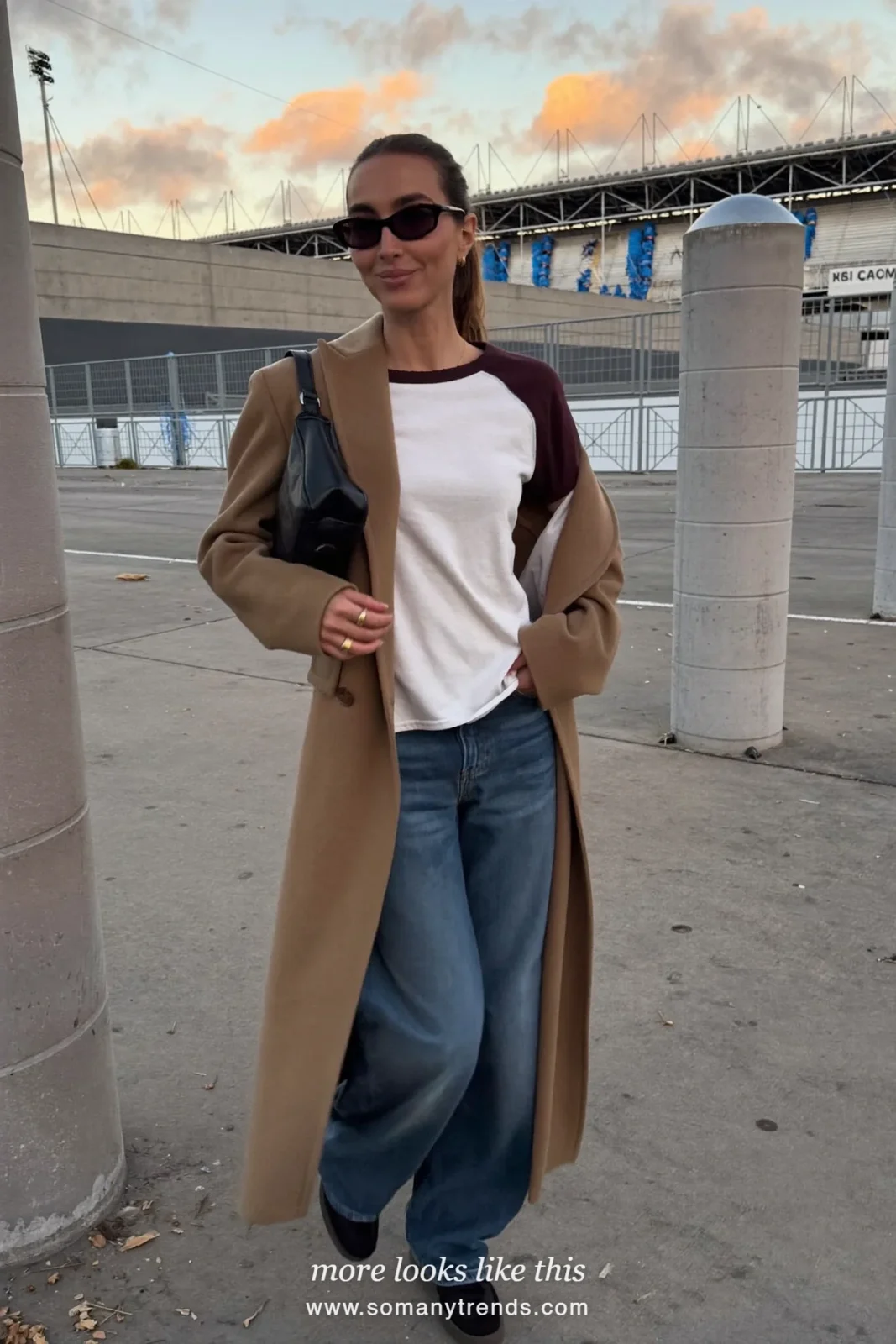 Long camel coat over wine baseball tee with straight jeans and black sneakers, outfit 17