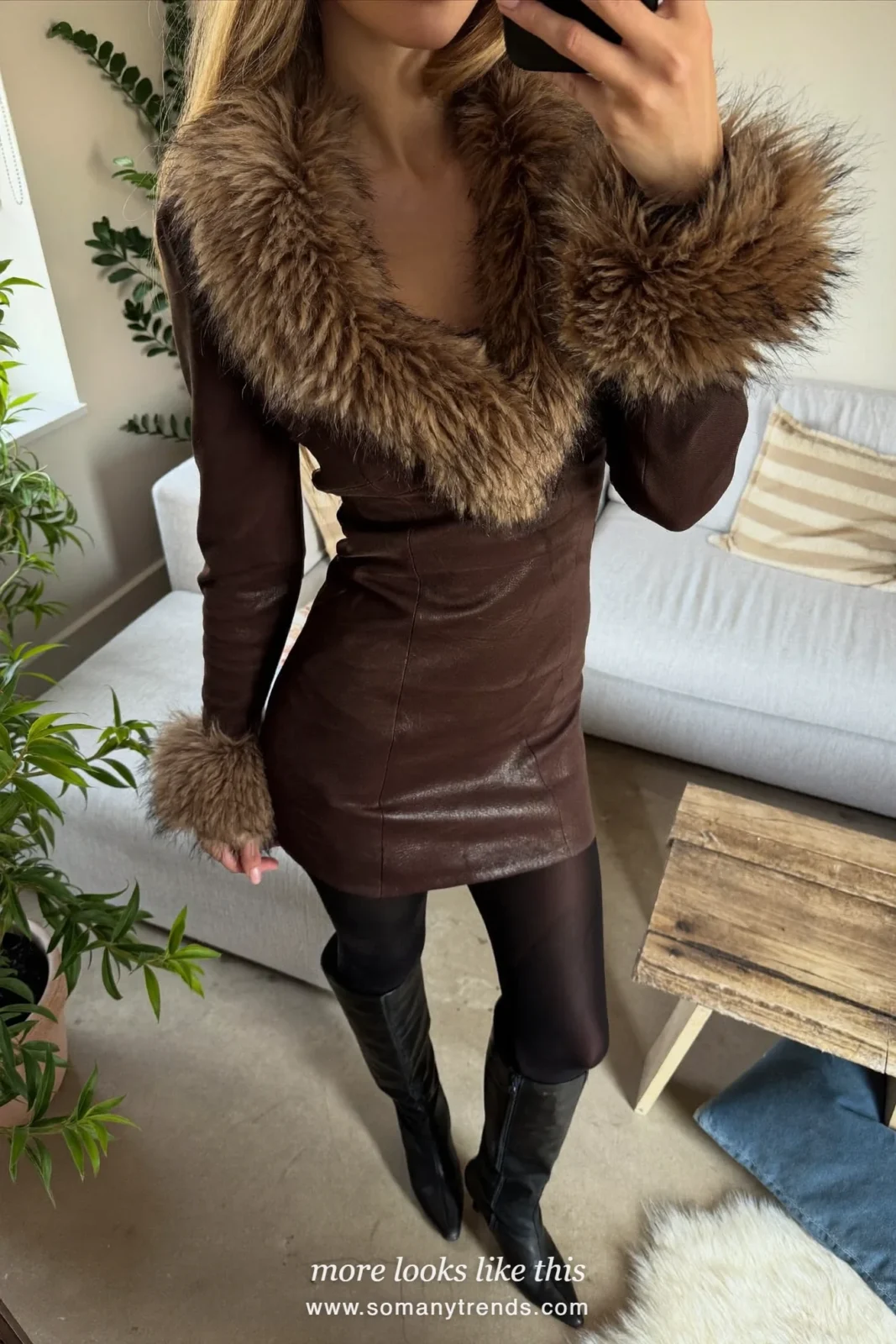 Woman in a chocolate brown mini dress with faux-fur trim, sheer tights and tall boots by a Christmas tree, outfit 8