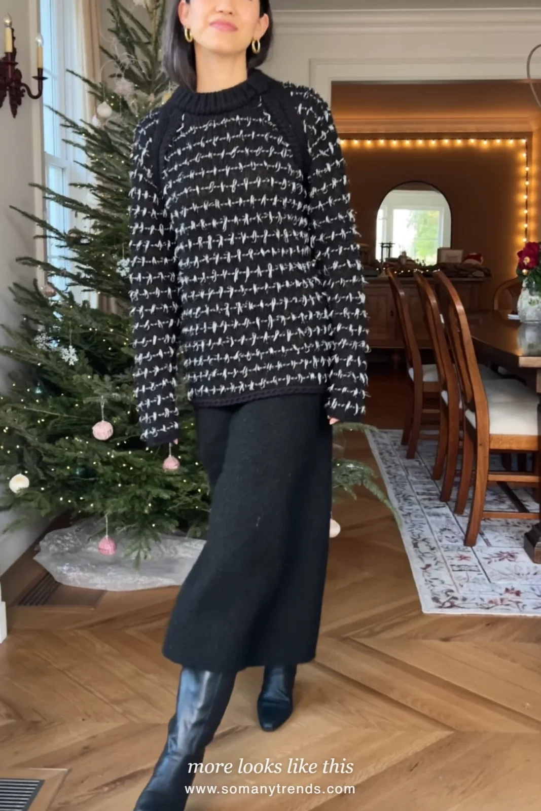 Woman in a black metallic-thread sweater, long black wool skirt and knee-high boots at a Christmas dinner, outfit 27