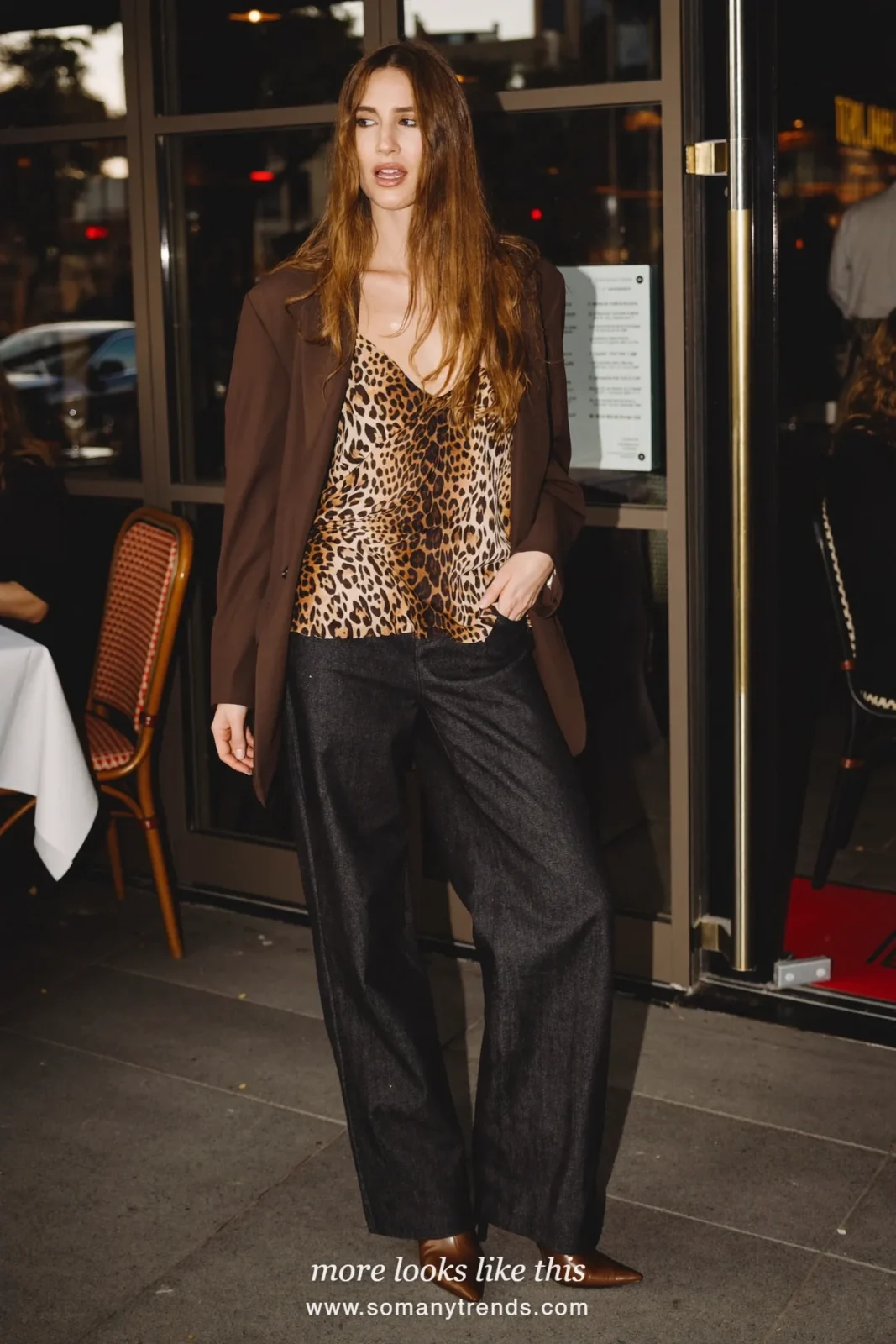 Woman in a leopard print camisole, brown long blazer, dark straight jeans and brown pointed boots, outfit 21