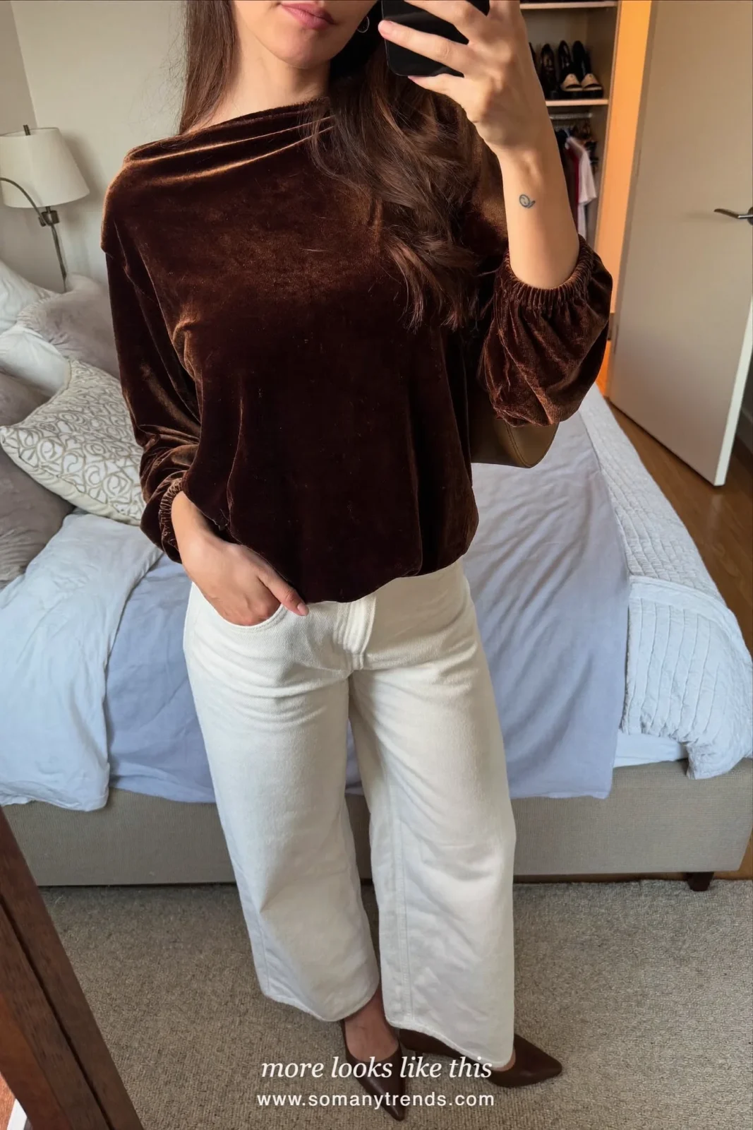 Woman in a chocolate brown velvet top with a bow, white straight jeans and brown kitten heels, outfit 28