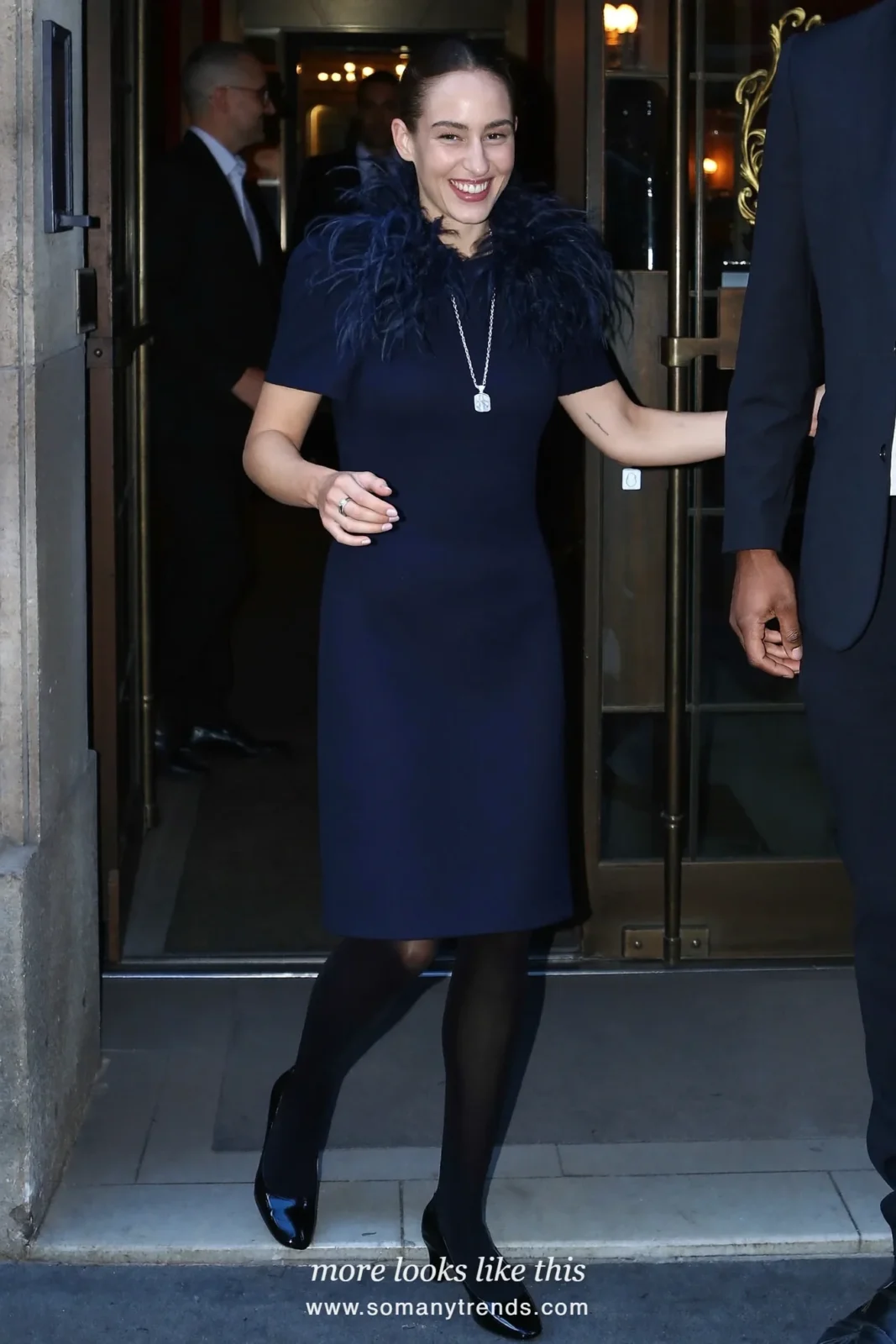 Woman in a navy dress with a feather collar, black tights and pumps, party outfit 17