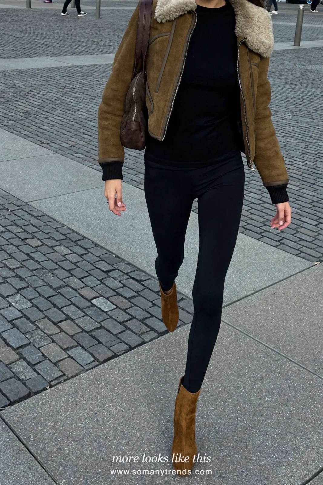 Woman in a short olive shearling aviator jacket, black leggings, suede boots and a suede bag, look 3