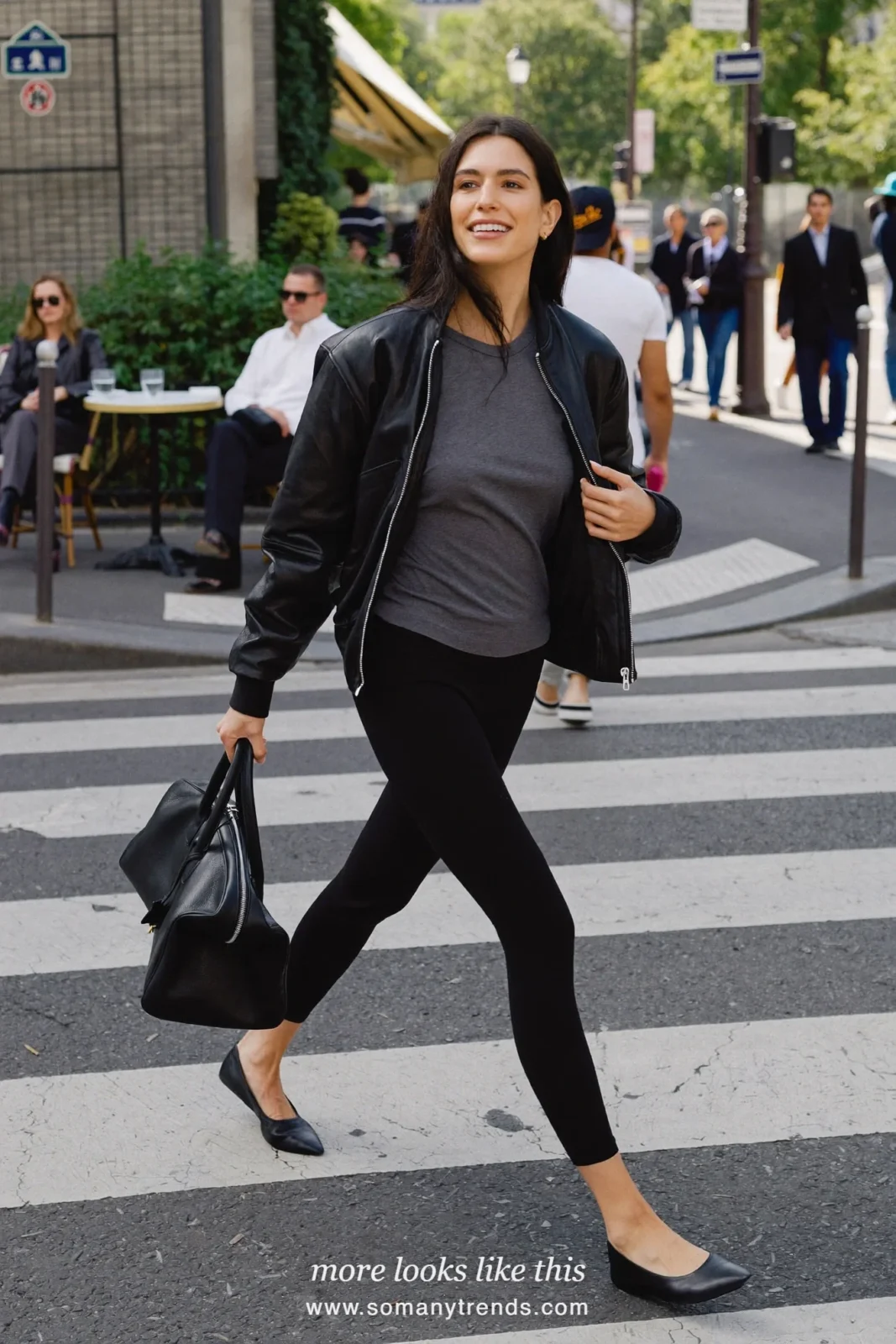 Woman in a black leather bomber, gray tee, black leggings, black pointed ballet flats and a large black bag, look 5