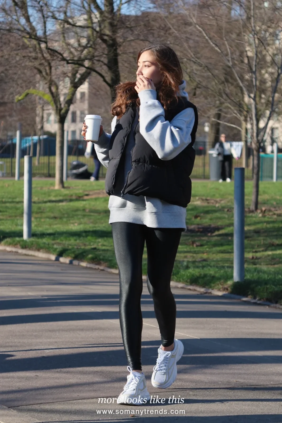 Gray hoodie, black puffer vest, black leggings, white sneakers and takeaway coffee, outfit 9