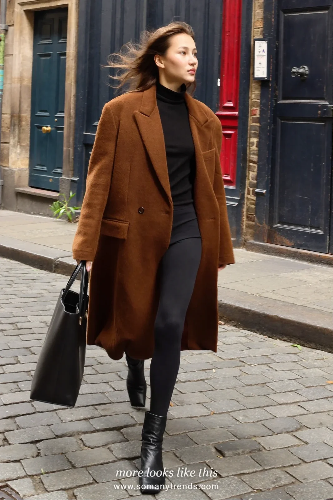 Woman in a long cognac wool coat, black turtleneck, black leggings, black ankle boots and a structured black tote, look 1