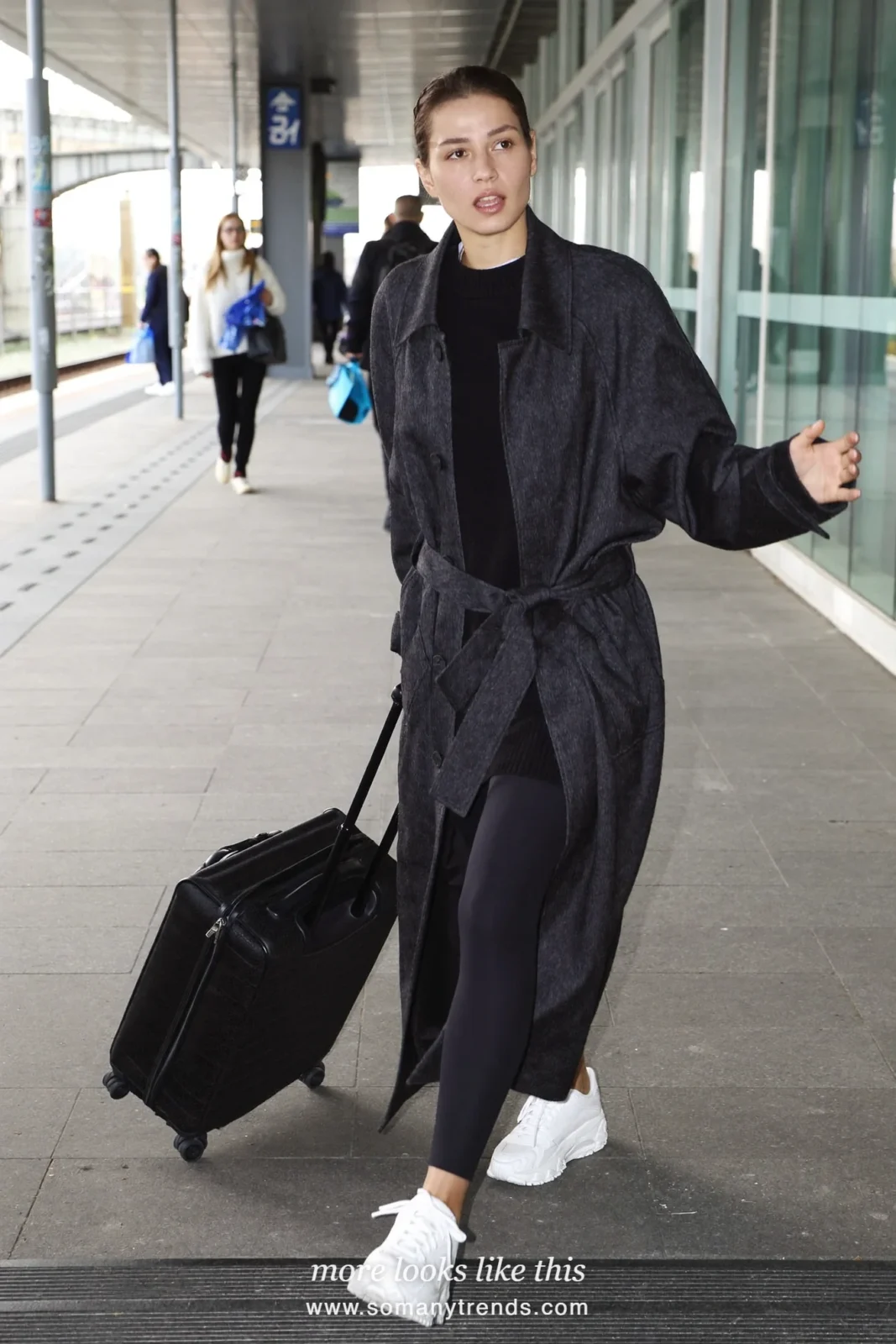 Long charcoal belted coat, black sweater, black leggings and white sneakers, outfit 18