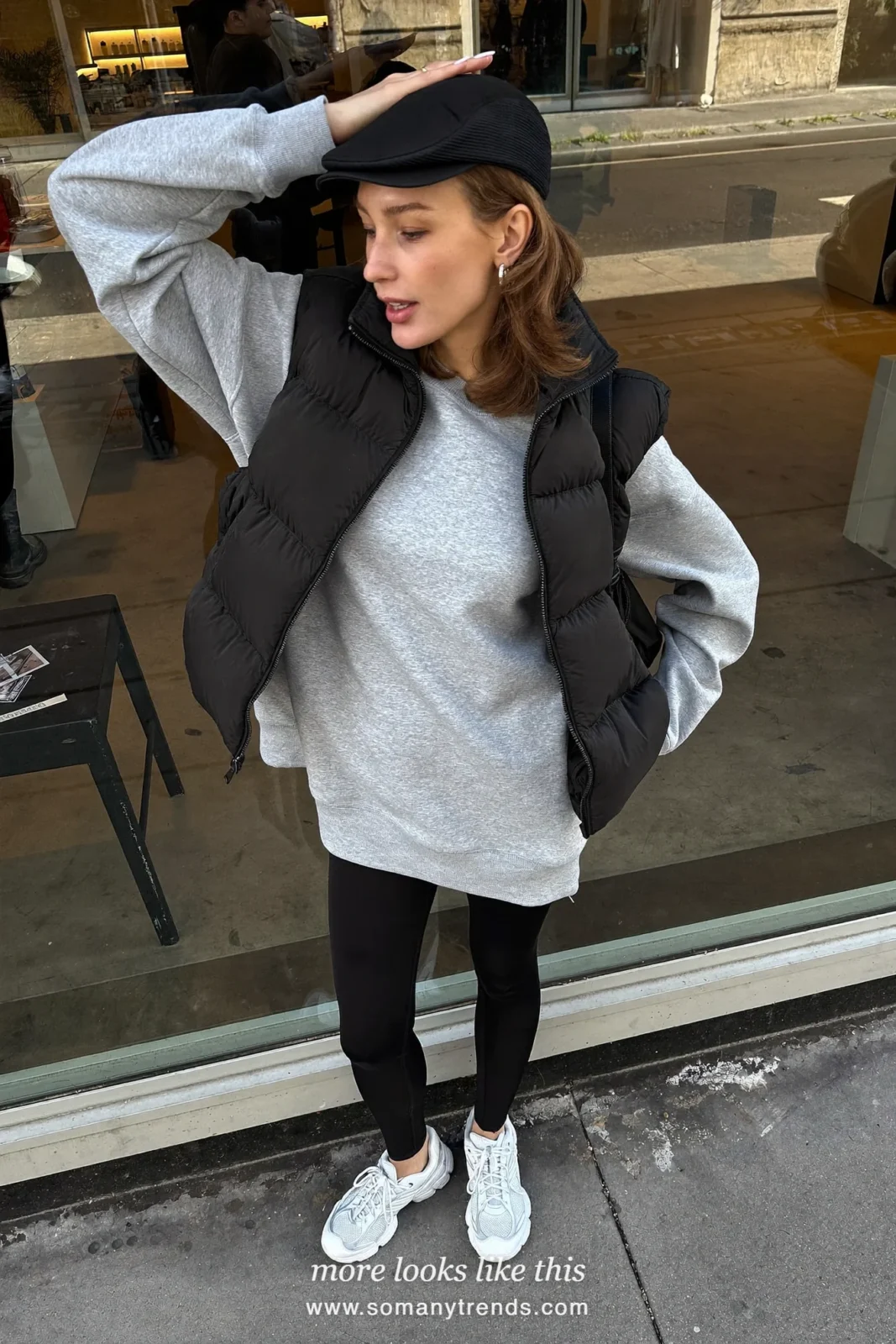 Long gray sweatshirt, black puffer vest, black leggings and white sneakers, outfit 22