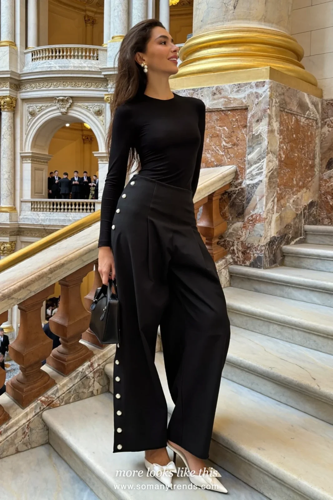 Woman in black wide pants with pearl buttons at the hem, fitted black top and white pointed kitten heels with a bow, cocktail outfit 10